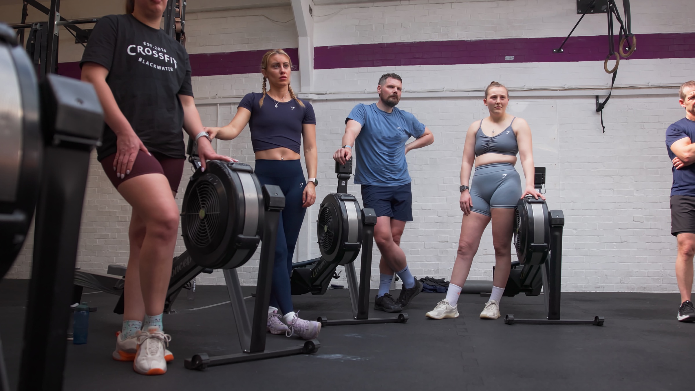A group of rowers listening during a performance workshop